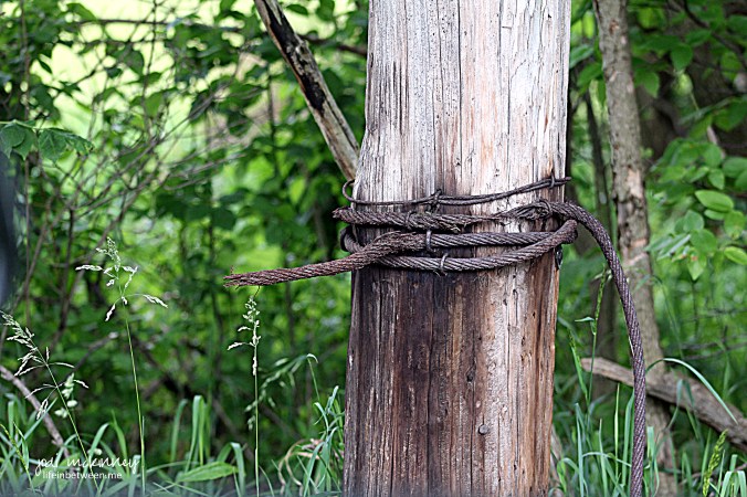 broken rope wire on fence post